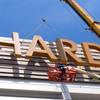 This Friday, May 4, 2018 photo shows part of the first sign for the soon-to-open Hard Rock Casino in Atlantic City N.J., being lifted into place on the building. As Atlantic City's casinos mark their 40th anniversary, the industry is hailing the reopening of two of the five casinos that shut down since 2014, though some worry that re-expanding the market could lead to the same conditions that caused the closings in the first place. Hard Rock, which is the former Trump Taj Majal, and Ocean Resort, which is the former Revel, are both due to open on June 28. 
