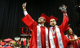Todeh Toomians, left, and Naweed Yusufzai, graduates in the College of Life Science, celebrate as they leave the stage during UNLV's 2018 Spring Commencement ceremony at the Thomas & Mack Center Saturday, May 12, 2018.