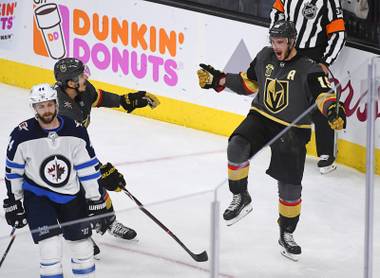 Vegas Golden Knights defenseman Luca Sbisa (47) and Vegas Golden Knights right wing Reilly Smith (19) celebrate Smith’s game-winning goal against the Winnipeg Jets  during Game 4 of their NHL hockey Western Conference Final game Friday, May 18, 2018, at T-Mobile Arena. The Golden Knights won 3-2.