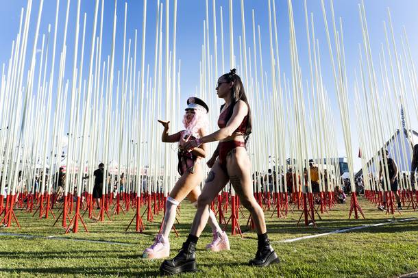Festivalgoers walk past The Hexatron art installation by artist Mark Lottor during the first night of the Electric Daisy Carnival at the Las Vegas Speedway, Friday, May 18, 2018.