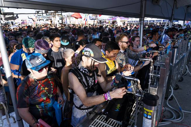 Hundreds of festivalgoers wait in the free water lines prior to the opening of the first night of the Electric Daisy Carnival at the Las Vegas Speedway, Friday, May 18, 2018.