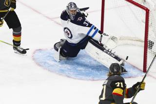 Vegas Golden Knights center William Karlsson (71) scores against Winnipeg Jets goaltender Connor Hellebuyck (37) during the first period of Game 4 of the NHL hockey playoffs Western Conference finals at T-Mobile Arena Friday, May 18, 2018.