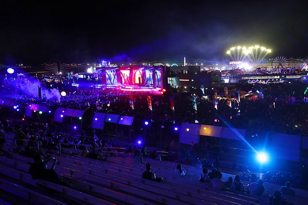 Festivalgoers get an overall view of the festival grounds from the grandstands during the Electric Daisy Carnival at the Las Vegas Motor Speedway Sunday morning, May 20, 2018. 