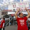 Union organizers Angie Qin, left, and David Saba hold signs as  members of the Culinary Workers Union, Local 226, file into the Thomas & Mack Center to vote on whether to authorize a strike Tuesday, May 22, 2018, in Las Vegas. A potential strike would affect 34 casino-hotels.