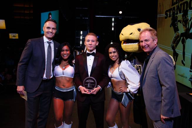 From left, Director of Marketing for the Raiders Brandon Clark, a Raider's cheerleader, Virgin Valley High School wrestler Ty Smith, a Raider's cheerleader, Golden Knights mascot Chance and John Barr of Findlay Toyota pose for a photo, after Ty Smith wins the Male Athlete of the Year award during the Las Vegas Sun Standout Awards at South Point, Wednesday, May 23, 2018.