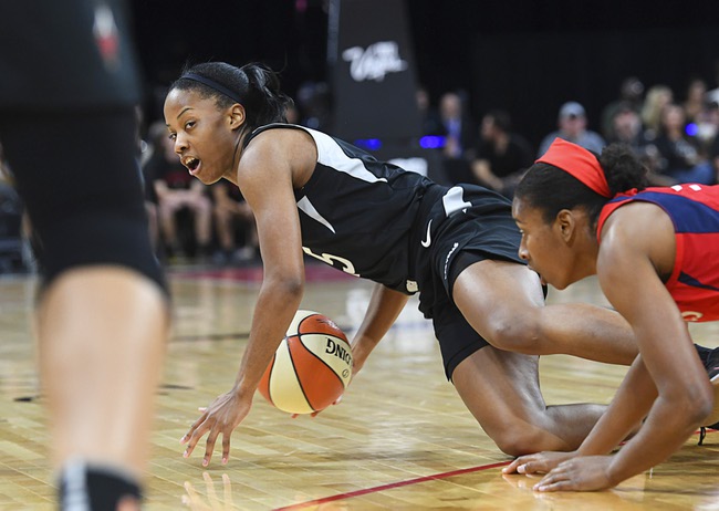 Las Vegas Aces forward Dearica Hamby (5) looks for a teammate to pass to while falling to the floor during the first half of their WNBA basketball game against the Washington Mystics Friday, June 1, 2018, at Mandalay Bay Events Center.