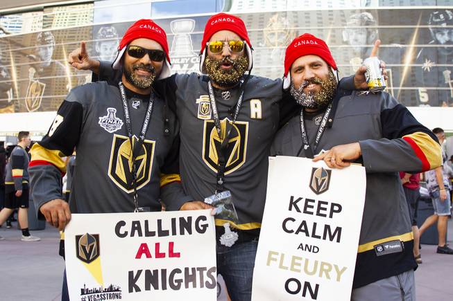 Golden Knights fans (from left) Jas Kaila, Joey and David Ramjeeawon pose for a photo during pregame festivities for Game 5 of the NHL Stanley Cup Final with the Vegas Golden Knights against the Washington Capitals at Toshiba Plaza outside T-Mobile Arena, Thursday, June 7, 2018.