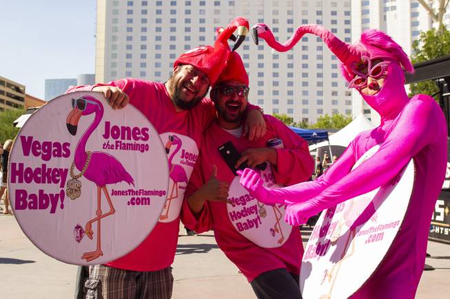 Flamigo dressed hockey fans pose for a photo during pregame festivities for Game 5 of the NHL Stanley Cup Final with the Vegas Golden Knights against the Washington Capitals at Toshiba Plaza outside T-Mobile Arena, Thursday, June 7, 2018.