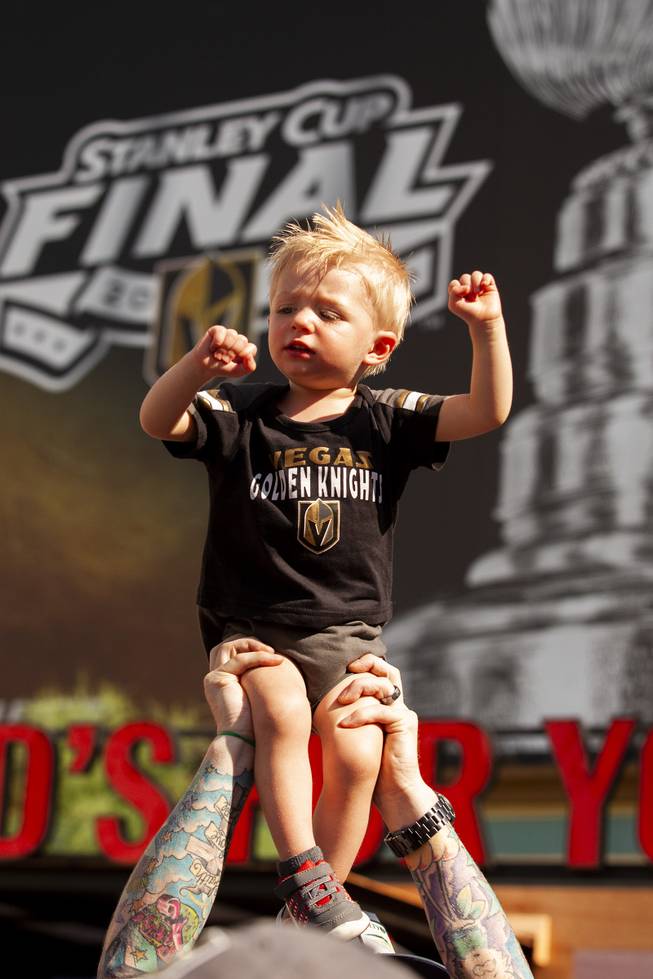 Jamesen Nowlan is lift above the crowd by his father during pregame festivities for Game 5 of the NHL Stanley Cup Final with the Vegas Golden Knights against the Washington Capitals at Toshiba Plaza outside T-Mobile Arena, Thursday, June 7, 2018.