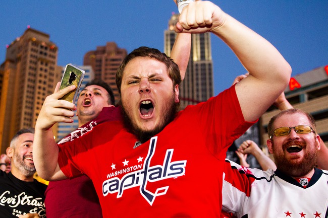Washington Capitals fans celebrate following the Capitals Game 5 NHL Stanley Cup Final 4-3 win against the Vegas Golden Knights at Toshiba Plaza outside T-Mobile Arena, Thursday, June 7, 2018.