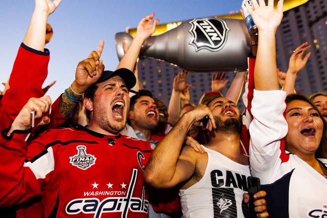 Washington Capitals fans celebrate following the Capitals Game 5 NHL Stanley Cup Final 4-3 win against the Vegas Golden Knights at Toshiba Plaza outside T-Mobile Arena, Thursday, June 7, 2018.