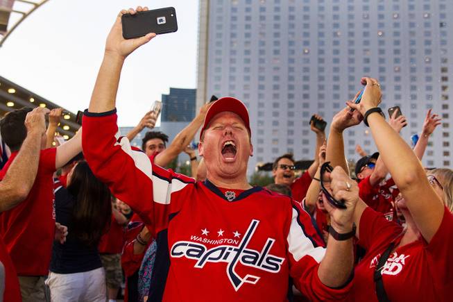 A Washington Capitals fan celebrates following the Capitals 4-3 Game 5 win over the Golden Knights during NHL Stanley Cup Final at Toshiba Plaza outside T-Mobile Arena, Thursday, June 7, 2018.