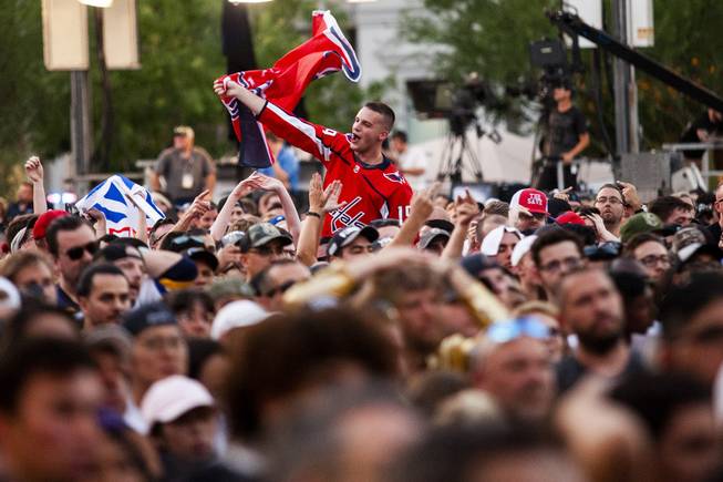 A Washington Capitals fan celebrates following a goal by the Capitals during the third period of Game 5 of the NHL Stanley Cup Final with the Washington Capitals against the Vegas Golden Knights at Toshiba Plaza outside T-Mobile Arena, Thursday, June 7, 2018.