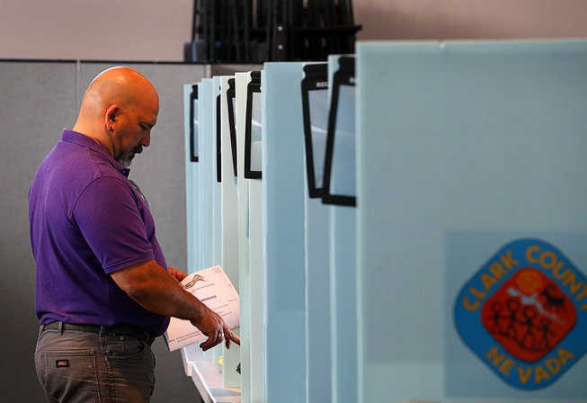 Milko Alvarez casts his ballot during primary election voting at ...