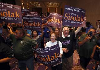 Veronica and Ron Wasak show their support for Democratic gubernatorial candidate Steve Sisolak during an election watch party at the Aria convention center Tuesday, June 12, 2018.