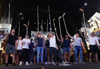 Vegas Golden Knights players, from left, Brayden McNabb (3), Jon Merrill (15), James Neal (18), Malcolm Subban (30), Reilly Smith (19), Cody Eakin (21), Pierre-Edouard Bellemare (41), Erik Haula (56), Nate Schmidt (88) and Alex Tuch (89), hold up hockey sticks during the team's 