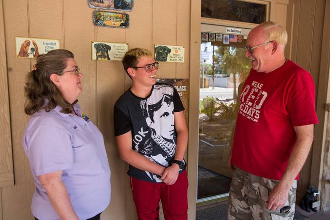 Val and Mark Goldstrom share a laugh with their soon-to-be adopted son Howard, middle, on the front porch of their home, Friday June 6, 2018.