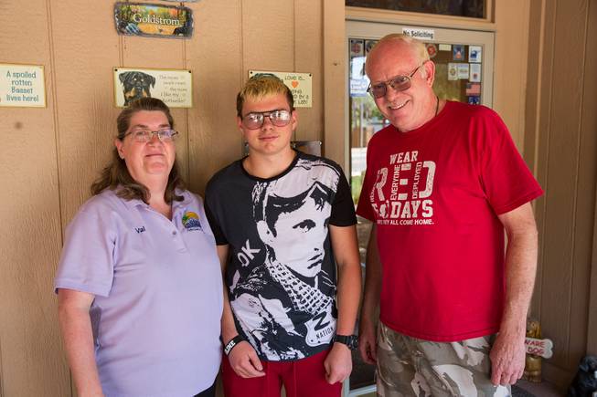 Val and Mark Goldstrom pose for a photo with their soon-to-be adopted son Howard, middle, on the front porch of their home, Friday June 6, 2018.