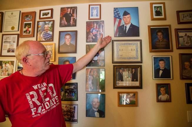 Mark Goldstrom, father to three adopted sons, points to a photo of his eldest son Randy, who had served in the Air Force, Friday June 6, 2018.