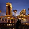 In this Jan. 12, 2015 file photo, a man takes pictures of Caesars Palace in Las Vegas. Unionized workers at the casino-resorts operated by Caesars Entertainment in Las Vegas cast ballots Thursday, June 14, 2018, to ratify their newly negotiated five-year contract. 