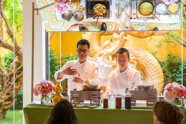 Chef Xian Ming Yu and Chef Alan Ji demonstrate how to cook three cup sea bass for guests during a Master Class at Wing Lei, Wynn, Friday June 15, 2018.