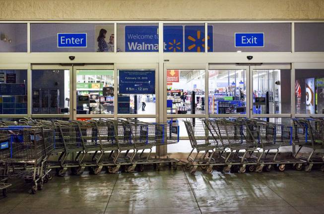 Shopping carts block an entrance to the Walmart Supercenter at 6464 N. Decatur Blvd. early Thursday, June 21, 2018. The store changed its hours in February from 24 hours a day to 6 a.m. to midnight. 