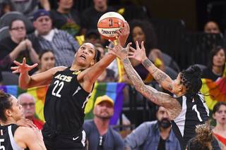 Las Vegas Aces center A'ja Wilson (22) and Las Vegas Aces forward Tamera Young (1) both reach for a rebound during their game against the New York Liberty Friday, June 22, 2018, at the Mandalay Bay Events Center. The Aces won 88-78.
