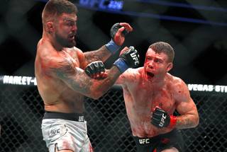 Mike Perry, left, takes a punch from Paul Felder in a lightweight bout during UFC 226 at T-Mobile Arena Saturday, July 7, 2018. Perry won the fight by split decision.