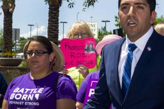 Fran Chomoqycz, center, holds up a pro-choice sign in front of her face during a NARAL Pro-choice Organization press conference held outside Dean Heller's office building in response to President Trump's SCOTUS nominee announcement, Tuesday, July 10, 2018.