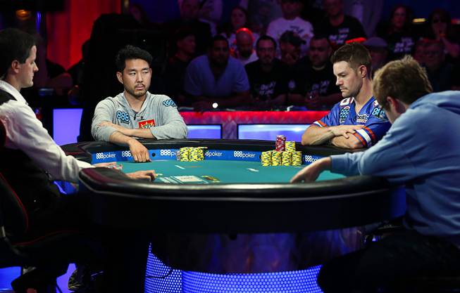 John Cynn, left, Tony Miles, center, and Michael Dyer compete in the World Series of Poker Main Event at the Rio Saturday, July 14, 2018.