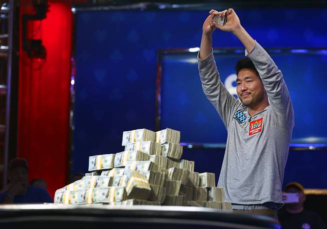 John Cynn holds up his championship bracelet after winning the World Series of Poker Main Event at the Rio Sunday morning, July 15, 2018. Cynn also won $8.8 million in prize money.