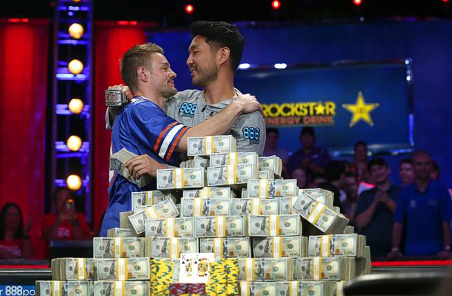 Second place finisher Tony Miles embraces winner John Cynn during the World Series of Poker Main Event at the Rio Sunday morning, July 15, 2018. Cynn won the championship bracelet and $8.8 million in prize money.