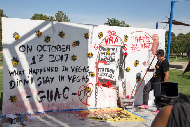 Manuel Oliver, father of Stoneman Douglas high school shooting victim Joaquin "Guac" Oliver, stands besides a mural he created that symbolizes the death of his son and a call for gun reform during the Road to Change event organized by the March for Our Lives organization at Sunset Park, Monday, July 16, 2018.