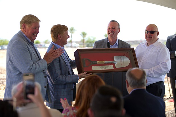 Kevin Burke, second right, president/CEO of Burke Construction, and Thad Lawrence, Burke Construction project executive, present a ceremonial shovel to Kem Gardner, left, chairman of the Gardner Company, and his son Christian, Gardner Company president and CEO,  during a groundbreaking ceremony for the first innovation building in the Harry Reid Research & Technology Park (UNLV Tech Park) on West Sunset Road near Durango Drive Tuesday, July 17, 2018.
