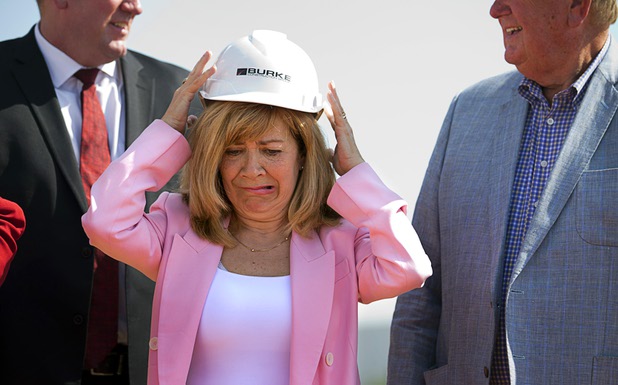 Marta Meana, acting president of UNLV, tries on a hard hat that was sized too small during a groundbreaking ceremony for the first innovation building in the Harry Reid Research & Technology Park (UNLV Tech Park) on West Sunset Road near Durango Drive Tuesday, July 17, 2018.