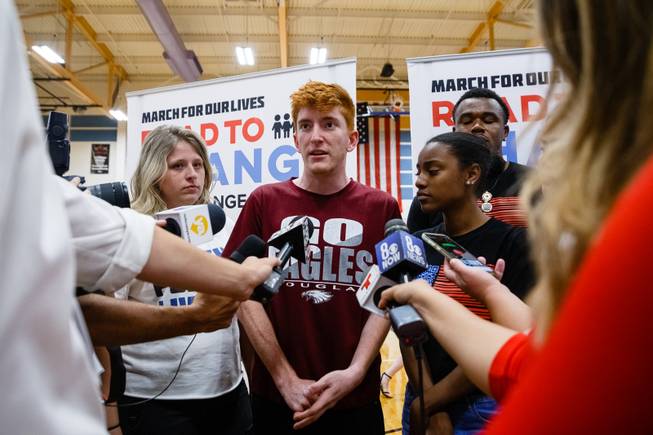 March for Our Lives activist and Stoneman Douglas high school shooting survivor Ryan Deitsch, center, speaks to reporters during the Road to Change gun control reform town hall at Sierra Vista High School, Monday, July 16, 2018.