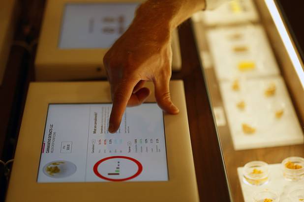A guest uses an touch-screen tablet to pull up information on marijuana concentrates during the grand opening of a MedMen marijuana dispensary, 823 S. 3rd St., in downtown Las Vegas Wednesday, July 18, 2018.