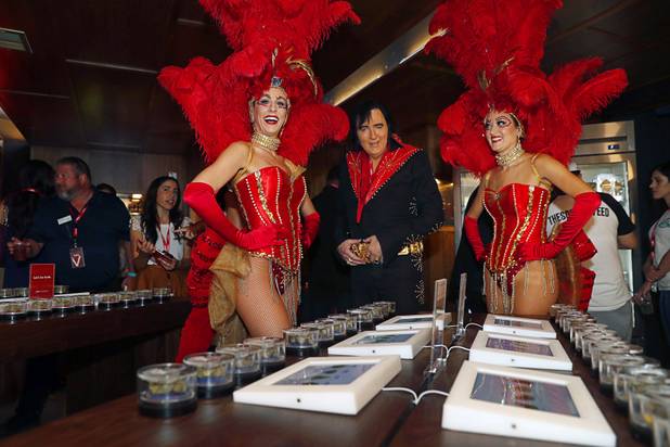Elvis Presley tribute artist Shane Paterson poses with showgirls Brittany Dunn, left, and Greta Jones during the grand opening of a MedMen marijuana dispensary, 823 S. 3rd St., in downtown Las Vegas Wednesday, July 18, 2018.