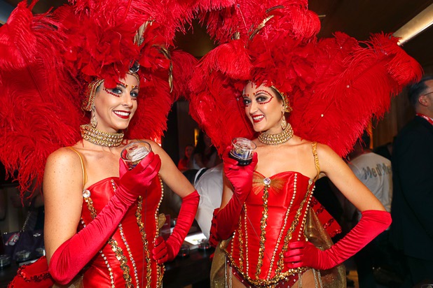 Showgirls Brittany Dunn, left, and Greta Jones pose with marijuana samples during the grand opening of a MedMen marijuana dispensary, 823 S. 3rd St., in downtown Las Vegas Wednesday, July 18, 2018.