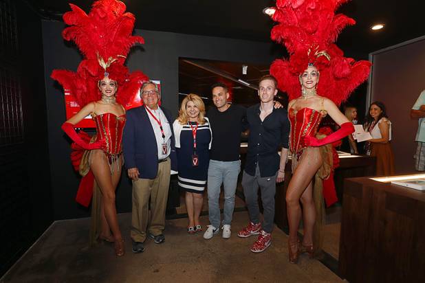 From left, State Sen. Tick Segerblom, D-Las Vegas, and candidate for Clark County Commission District E,, Las Vegas City Councilwoman Michelle Fiore, and MedMen co-founders Adam Bierman and Andrew Modlin pose between showgirls during the grand opening of a MedMen marijuana dispensary, 823 S. 3rd St., in downtown Las Vegas Wednesday, July 18, 2018.