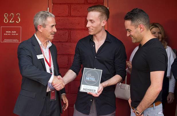 Art Goldberg, left, business development officer with the Las Vegas Metro Chamber of Commerce, welcomes MedMen co-founders Andrew Modlin, center, and Adam Bierman to downtown Las Vegas during the grand opening of a MedMen marijuana dispensary, 823 S. 3rd St., Wednesday, July 18, 2018.