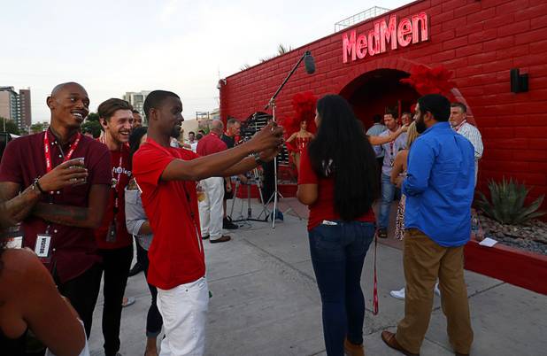 Staff members and guests take photos outside a MedMen marijuana dispensary, 823 S. 3rd St., in downtown Las Vegas Wednesday, July 18, 2018.
