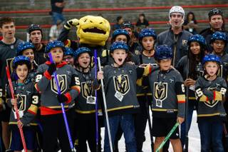 UMC pediatric patients pose for a photo with Golden Knights center Ryan Carpenter, mascot Chance, and officials during the 