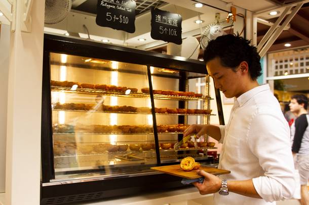Tony Chong serves up Portuguese Egg Tarts at his Pastel De Nata 1881 stand at the North Premium Outletss.