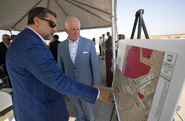 Kevin Higgins, executive vice president at CBRE, and Michael Dermody, president/CEO of Dermody Properties, look over a pipeline map during a water pipeline groundbreaking ceremony near Speedway Boulevard and Centennial Parkway in North Las Vegas Tuesday, July 31, 2018. The pipeline, expected to be completed in late 2020, will jumpstart development in the Apex Industrial Park, officials said.