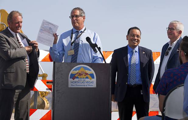 Dale Daffern, director of North Las Vegas public works, holds up the construction permit during a water pipeline groundbreaking ceremony near Speedway Boulevard and Centennial Parkway in North Las Vegas Tuesday, July 31, 2018. Also pictured, from left, are North Las Vegas Mayor John Lee, Alfredo Melesio Jr., director of land development and community services, and Randall DeVaul, director of utilities. The pipeline, expected to be completed in late 2020, will jumpstart development in the Apex Industrial Park, officials said.