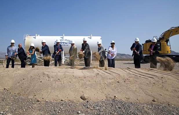 Las Vegas Mayor John Lee, center, and other officials take part in a water pipeline groundbreaking ceremony near Speedway Boulevard and Centennial Parkway in North Las Vegas Tuesday, July 31, 2018. The pipeline, expected to be completed in late 2020, will jumpstart development in the Apex Industrial Park, officials said.