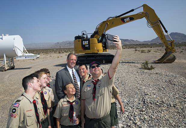 Las Vegas Mayor John Lee poses for a photo with Scoutmaster Matt Motl and Boy Scouts with Troop 306 during a water pipeline groundbreaking ceremony near Speedway Boulevard and Centennial Parkway in North Las Vegas Tuesday, July 31, 2018. The pipeline, expected to be completed in late 2020, will jumpstart development in the Apex Industrial Park, officials said.