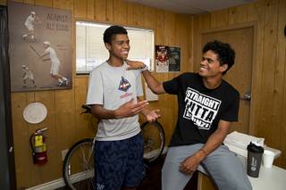 Rua Elmore, 16, stands by his brother Will Elmore, 23, during an interview at the No Quit Tennis Academy at Lorenzi Park Wednesday, Aug. 1, 2018.