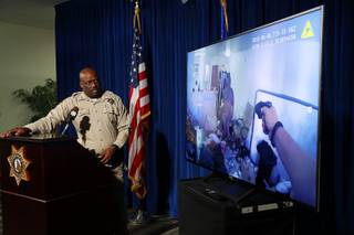 Assistant Sheriff Tim Kelly watches police body cam video during a briefing at Metro Police headquarters Thursday, Aug. 9, 2018. Police discussed the officer-involved shooting of Spurgeon Daniels at Kensington Suites, in the 2200 block of West Bonanza Road, Monday, Aug. 6. In this photo, an officer holds a Taser but the Taser was not effective, police said.